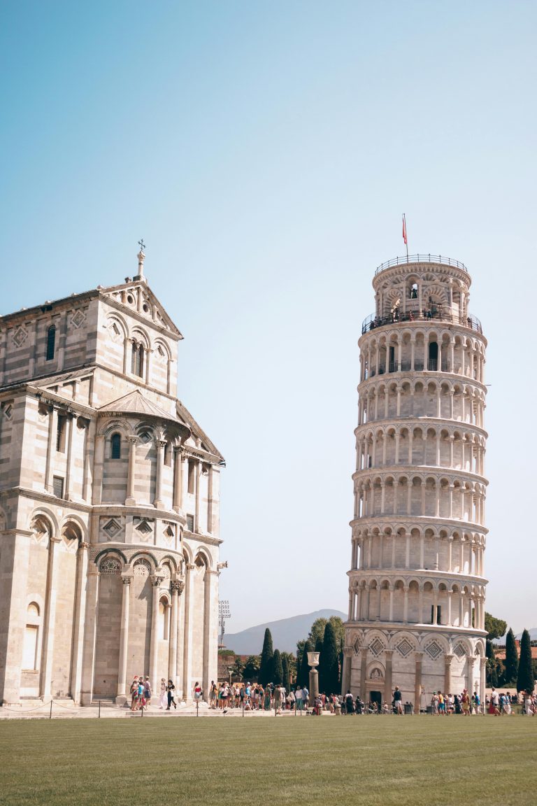 Iconic Leaning Tower of Pisa and cathedral under clear skies in Pisa, Italy.