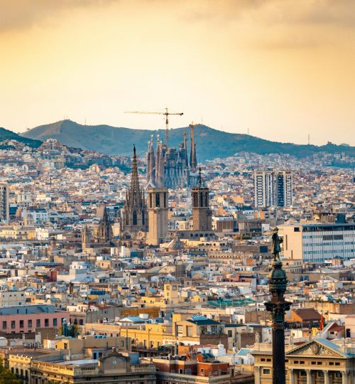 A breathtaking aerial view of Barcelona featuring the iconic Sagrada Familia at sunset.